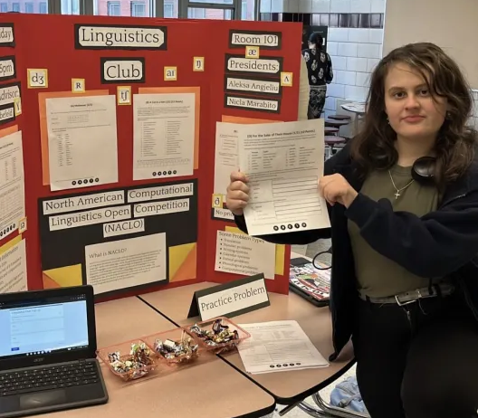 The posterboard for linguistics club at the EC fair, with former president Aleksa on the right